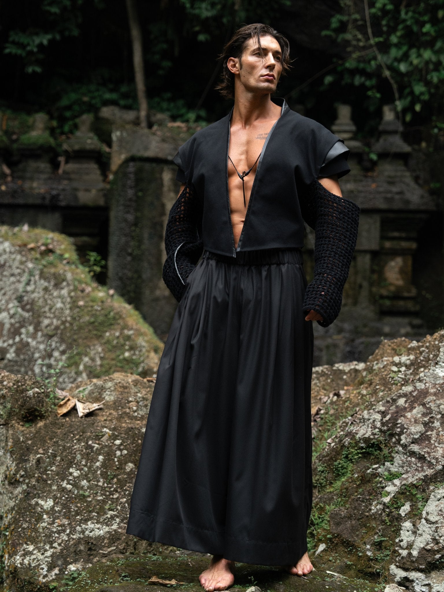 Black wide-leg Japanese hakama pants with an elastic waistband and two front pockets, combining traditional silhouette with modern comfort and versatility — perfect for everyday wear and expressive styling.