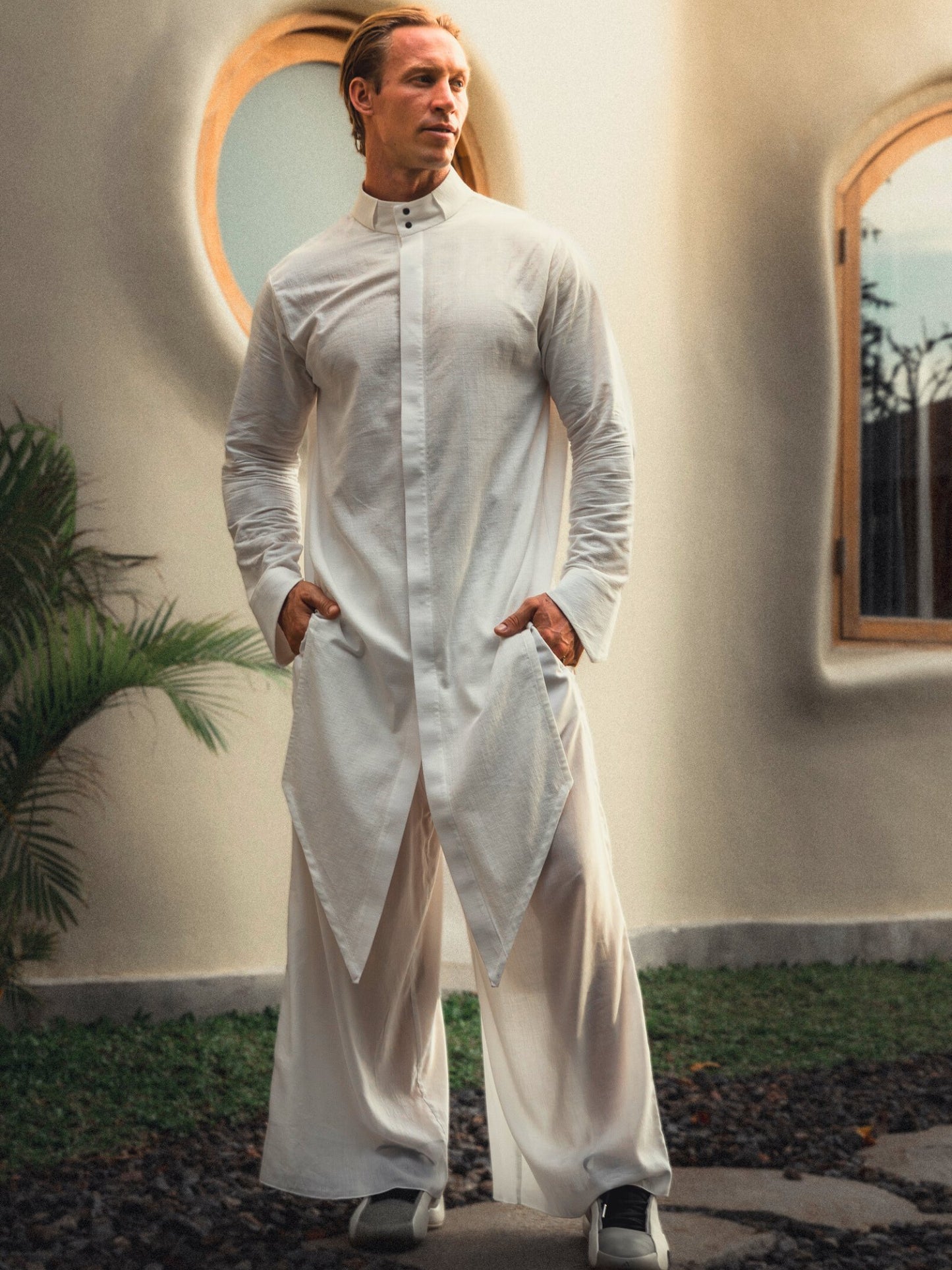 Shop the elegant long shirt made of 100% cotton. Featuring a stylish asymmetrical design, sealed cuffs, and a stand-up collar, this shirt combines modern style with comfort. Perfect for both casual and formal looks.
