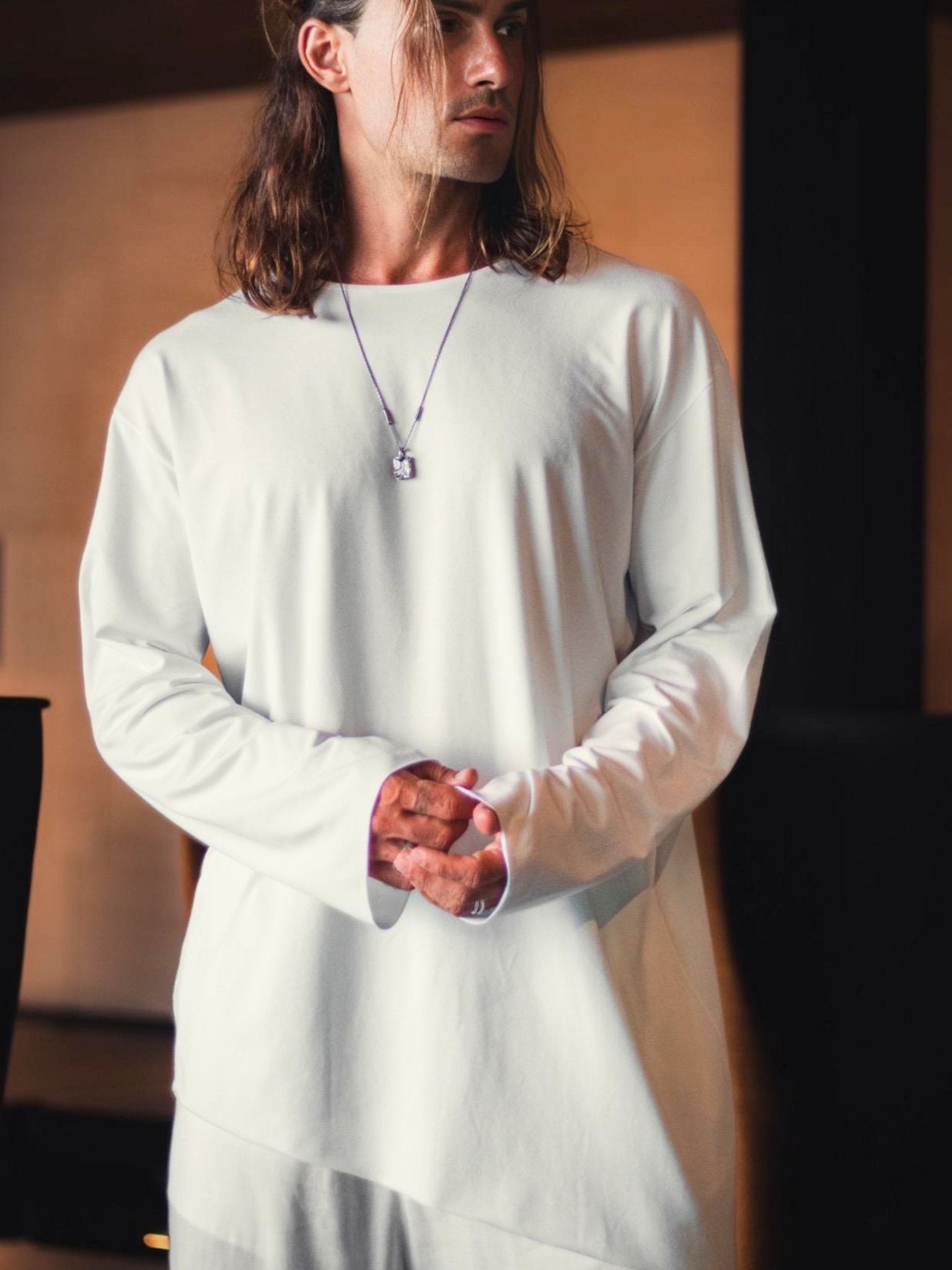 Asymmetric black oversized longsleeve made from bamboo fabric with a round neckline, offering comfort, breathability, and easy care without frequent ironing.