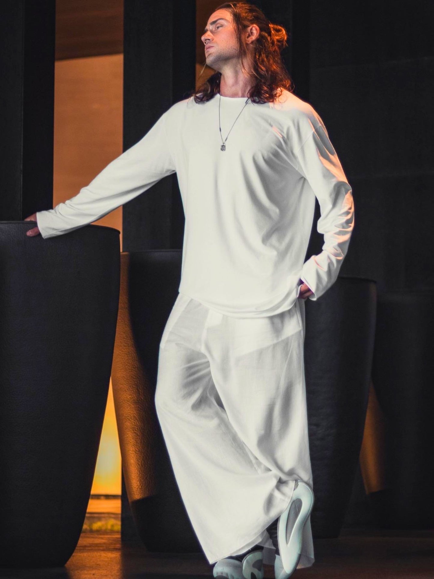 Asymmetric black oversized longsleeve made from bamboo fabric with a round neckline, offering comfort, breathability, and easy care without frequent ironing.