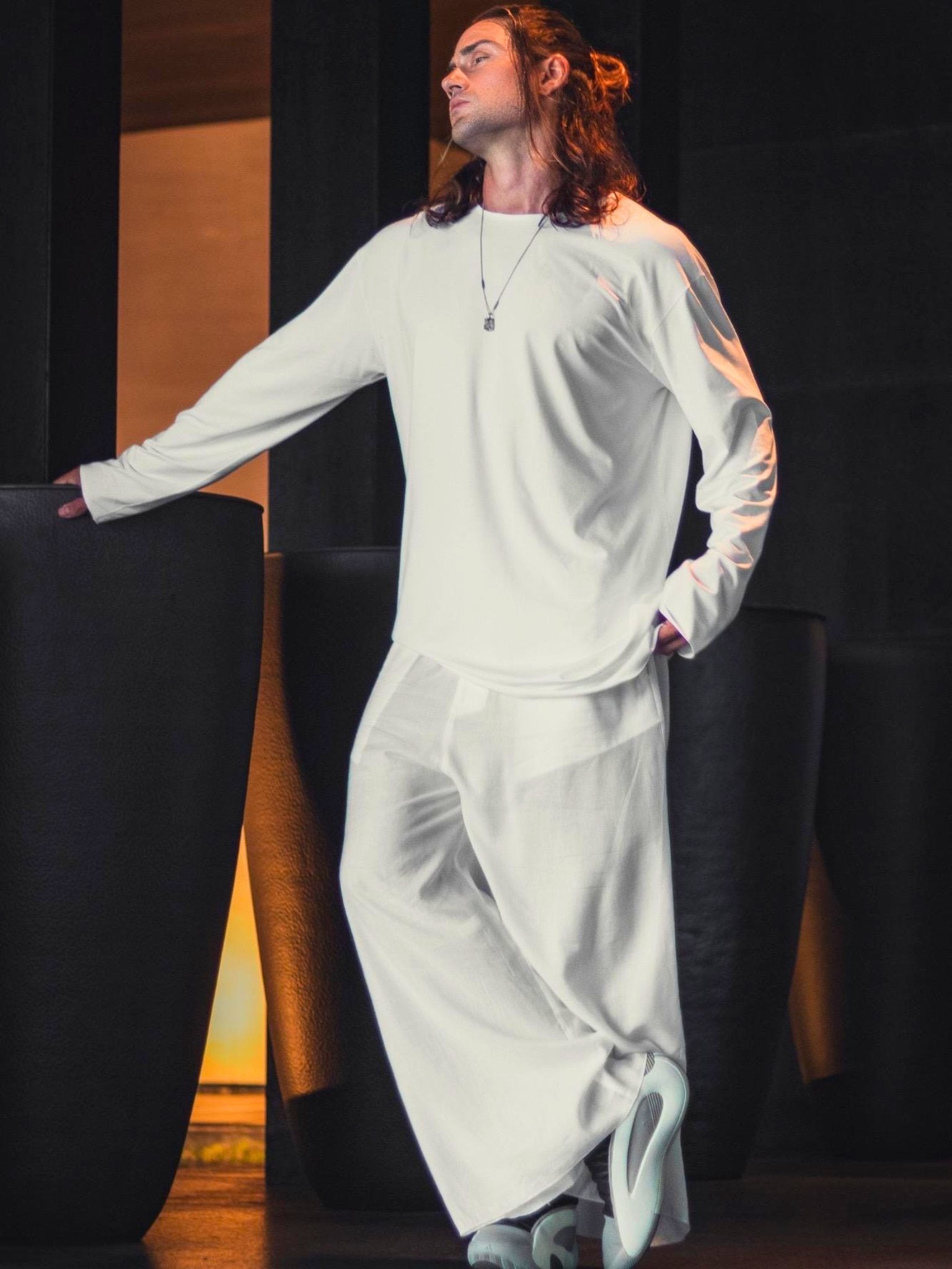 Asymmetric black oversized longsleeve made from bamboo fabric with a round neckline, offering comfort, breathability, and easy care without frequent ironing.