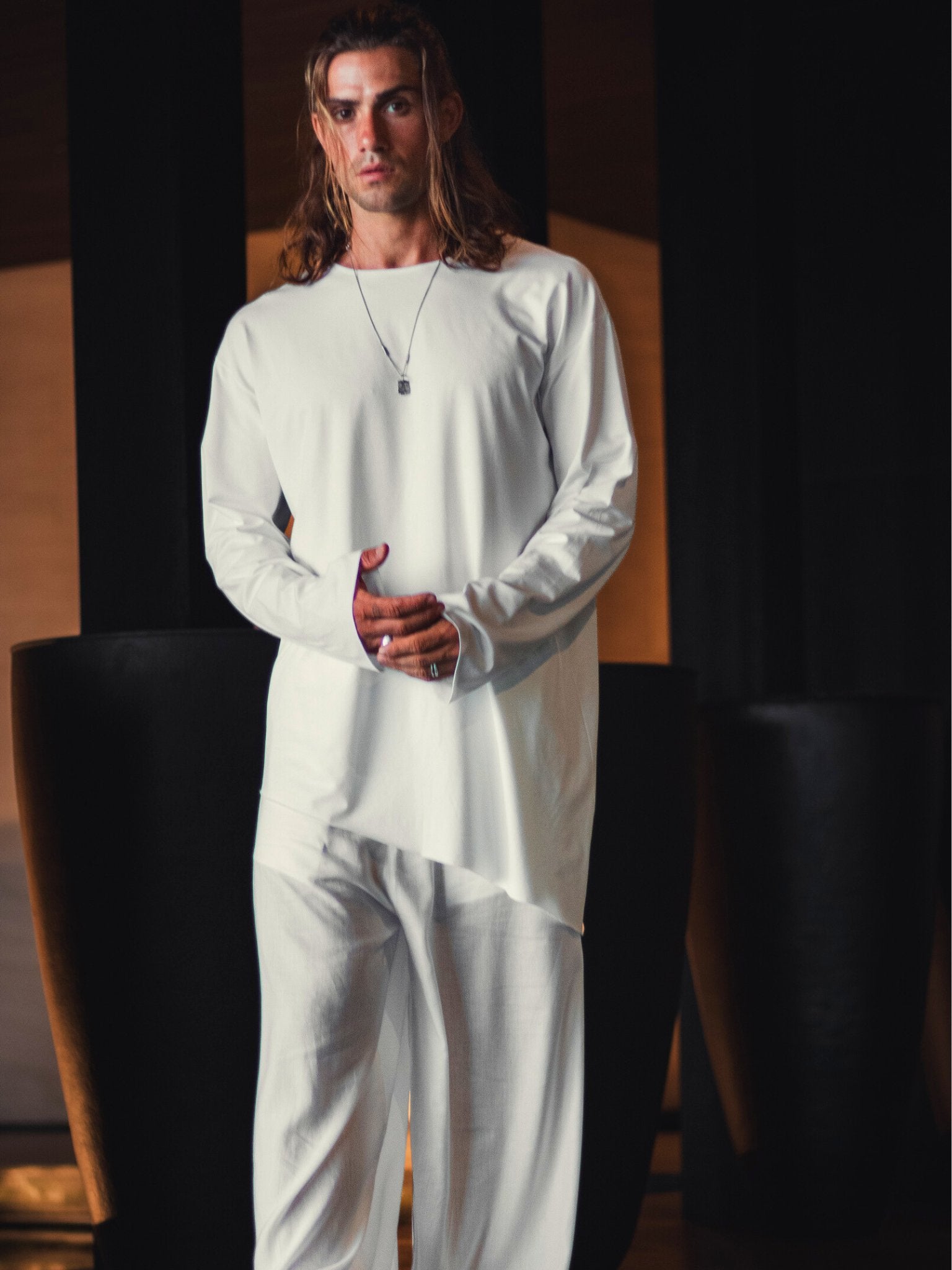 Asymmetric black oversized longsleeve made from bamboo fabric with a round neckline, offering comfort, breathability, and easy care without frequent ironing.