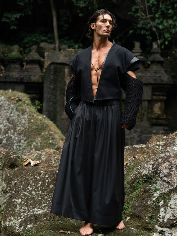 Black wide-leg Japanese hakama pants with an elastic waistband and two front pockets, combining traditional silhouette with modern comfort and versatility — perfect for everyday wear and expressive styling.