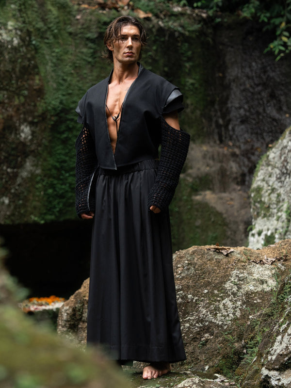 Black wide-leg Japanese hakama pants with an elastic waistband and two front pockets, combining traditional silhouette with modern comfort and versatility — perfect for everyday wear and expressive styling.