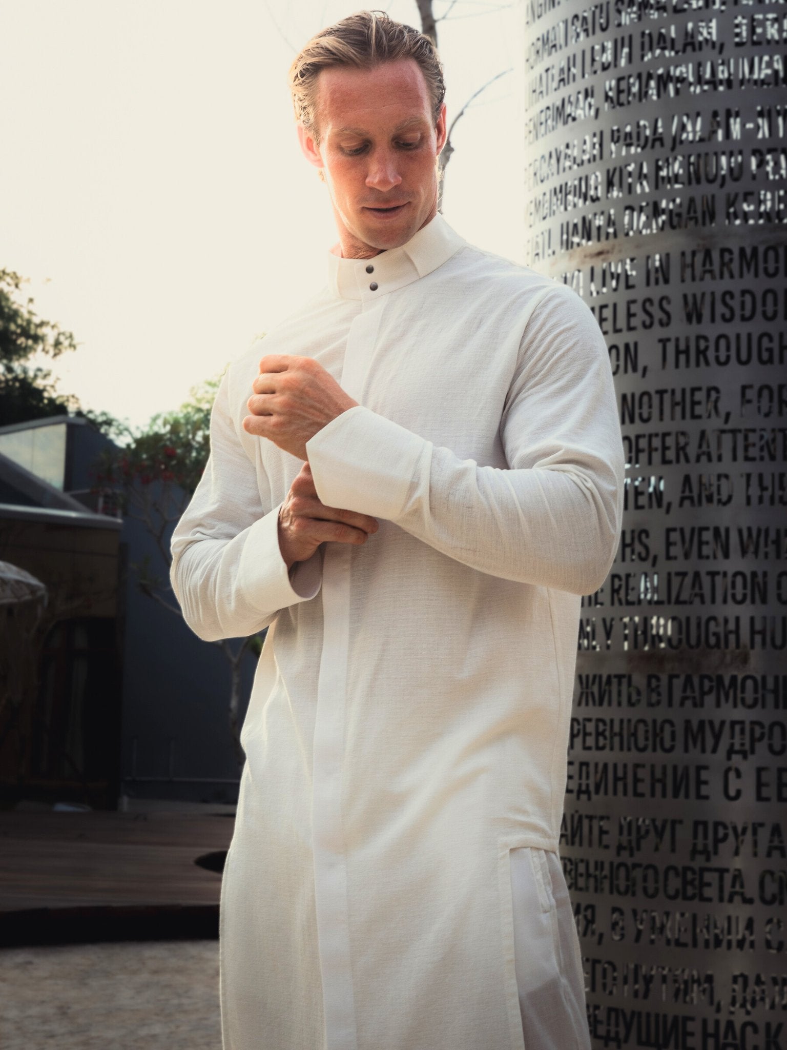 Shop the elegant long shirt made of 100% cotton. Featuring a stylish asymmetrical design, sealed cuffs, and a stand-up collar, this shirt combines modern style with comfort. Perfect for both casual and formal looks.