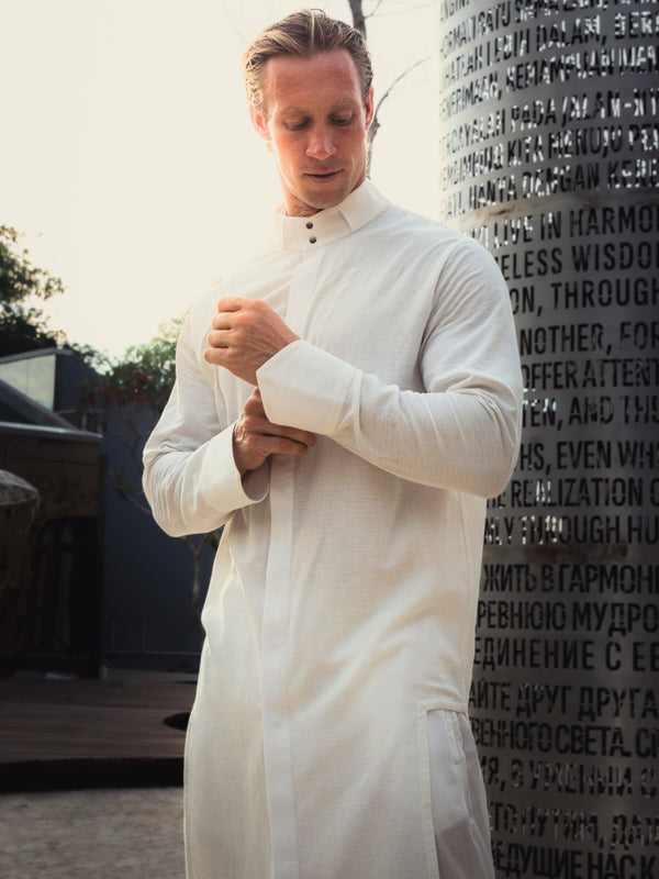 Shop the elegant long shirt made of 100% cotton. Featuring a stylish asymmetrical design, sealed cuffs, and a stand-up collar, this shirt combines modern style with comfort. Perfect for both casual and formal looks.