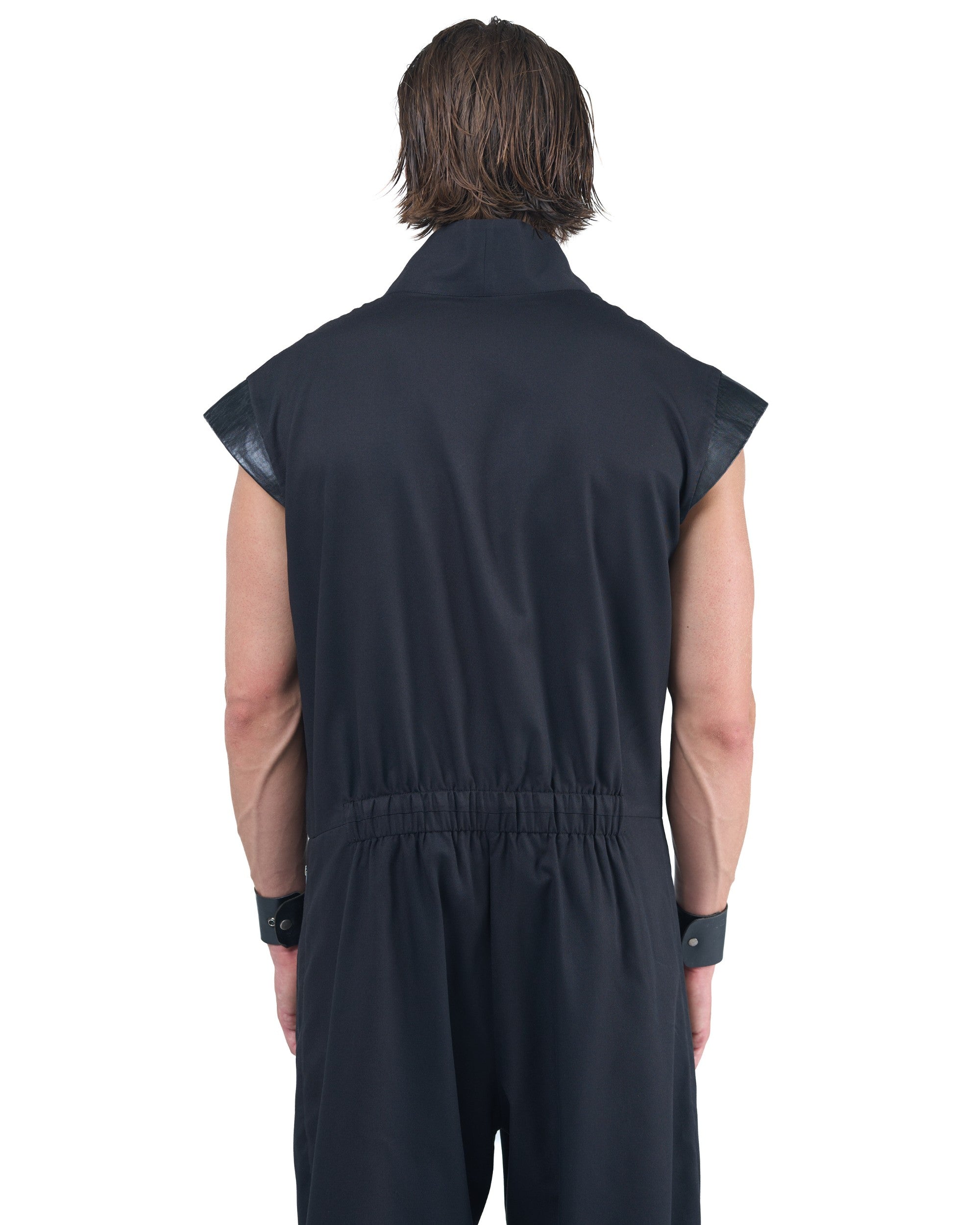 Black asymmetric jumpsuit with leather shoulders and diagonal zip closure by OVERZ