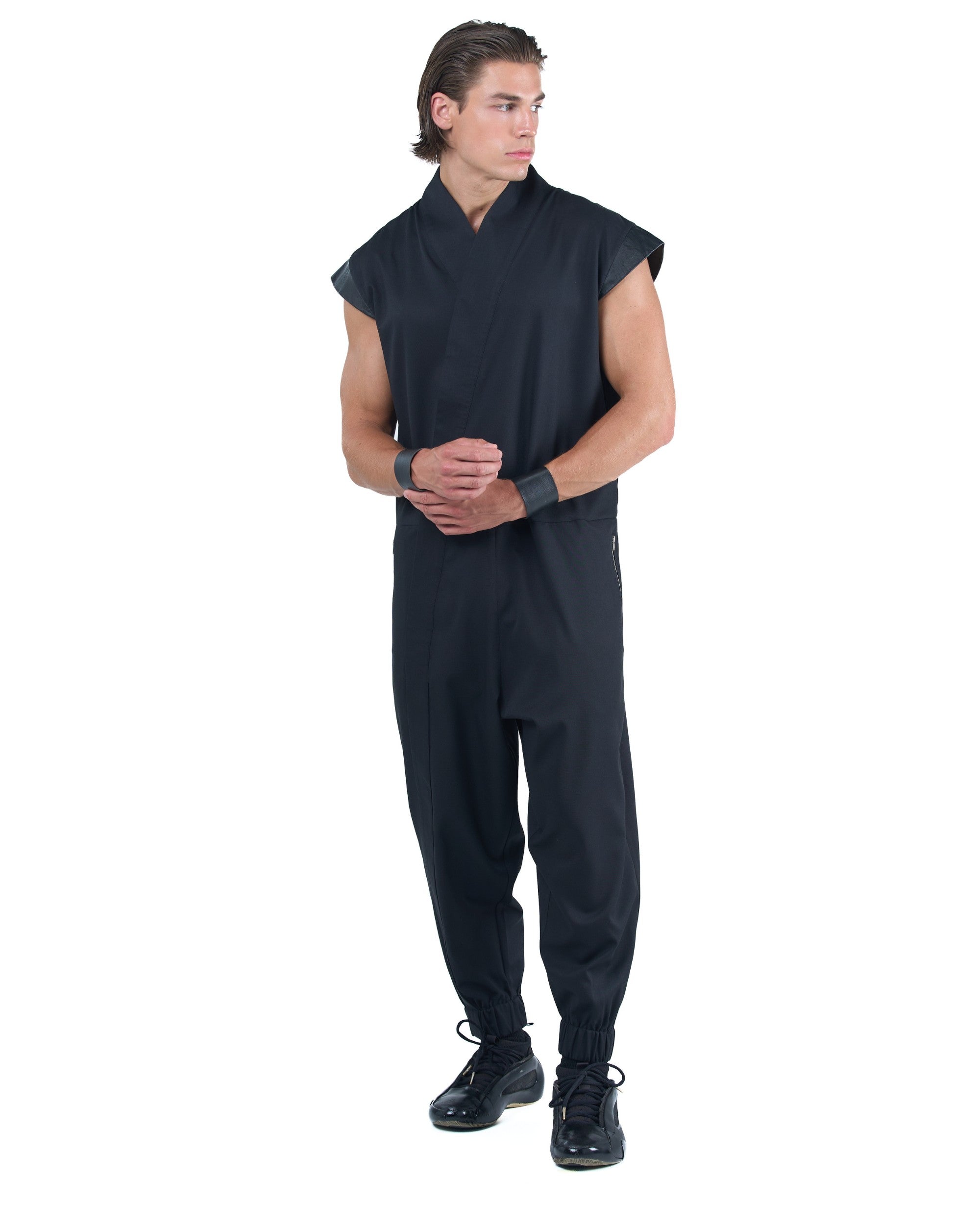 Black asymmetric jumpsuit with leather shoulders and diagonal zip closure by OVERZ