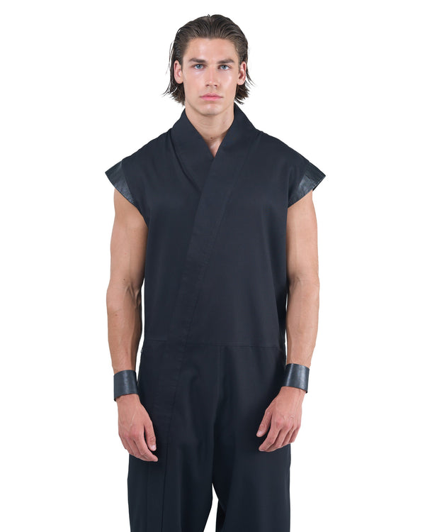 Black asymmetric jumpsuit with leather shoulders and diagonal zip closure by OVERZ
