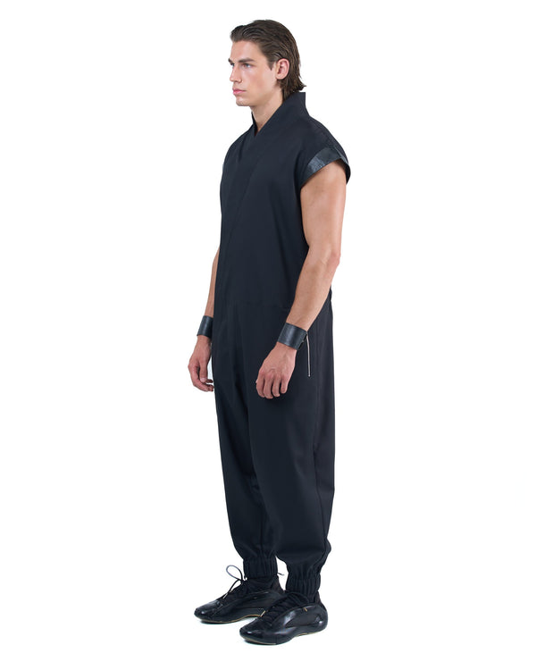 Black asymmetric jumpsuit with leather shoulders and diagonal zip closure by OVERZ