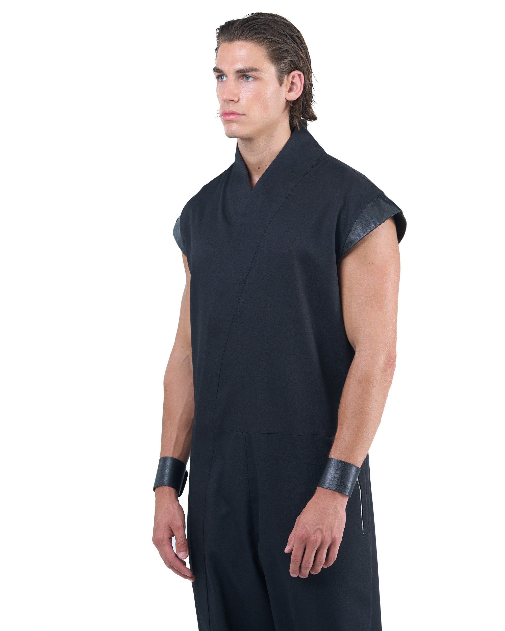 Black asymmetric jumpsuit with leather shoulders and diagonal zip closure by OVERZ