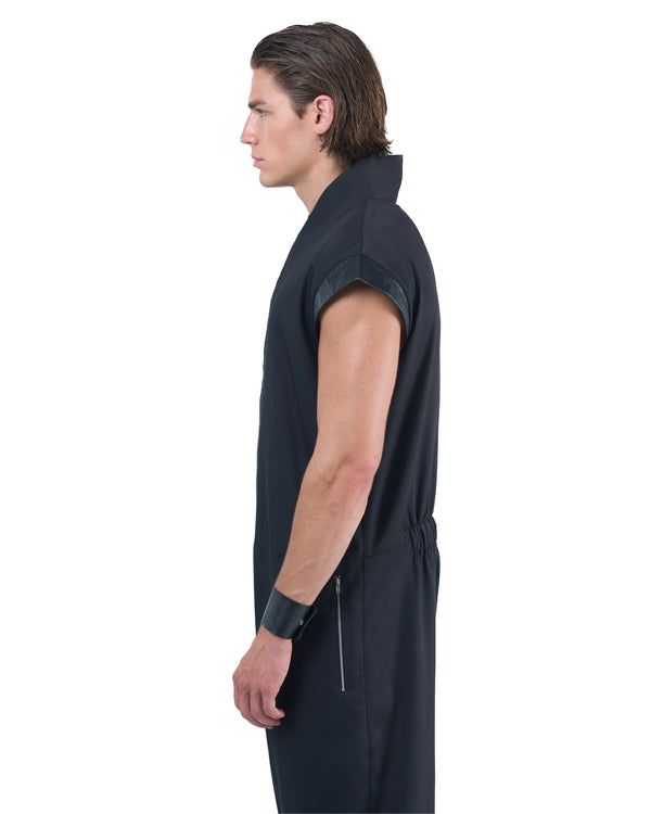 Black asymmetric jumpsuit with leather shoulders and diagonal zip closure by OVERZ
