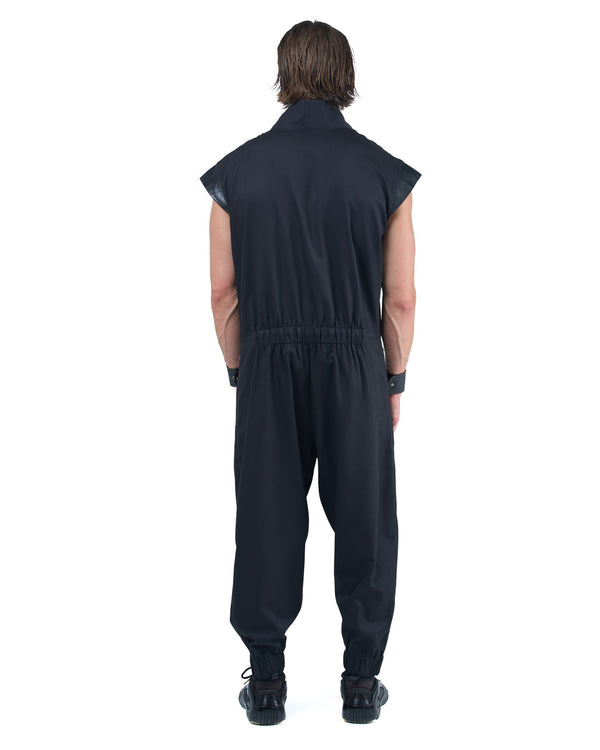 Black asymmetric jumpsuit with leather shoulders and diagonal zip closure by OVERZ