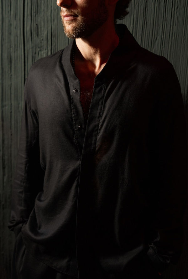 Black minimalist men’s shirt by OVERZ, lightweight breathable fabric, relaxed tailored fit, menswear Bali store