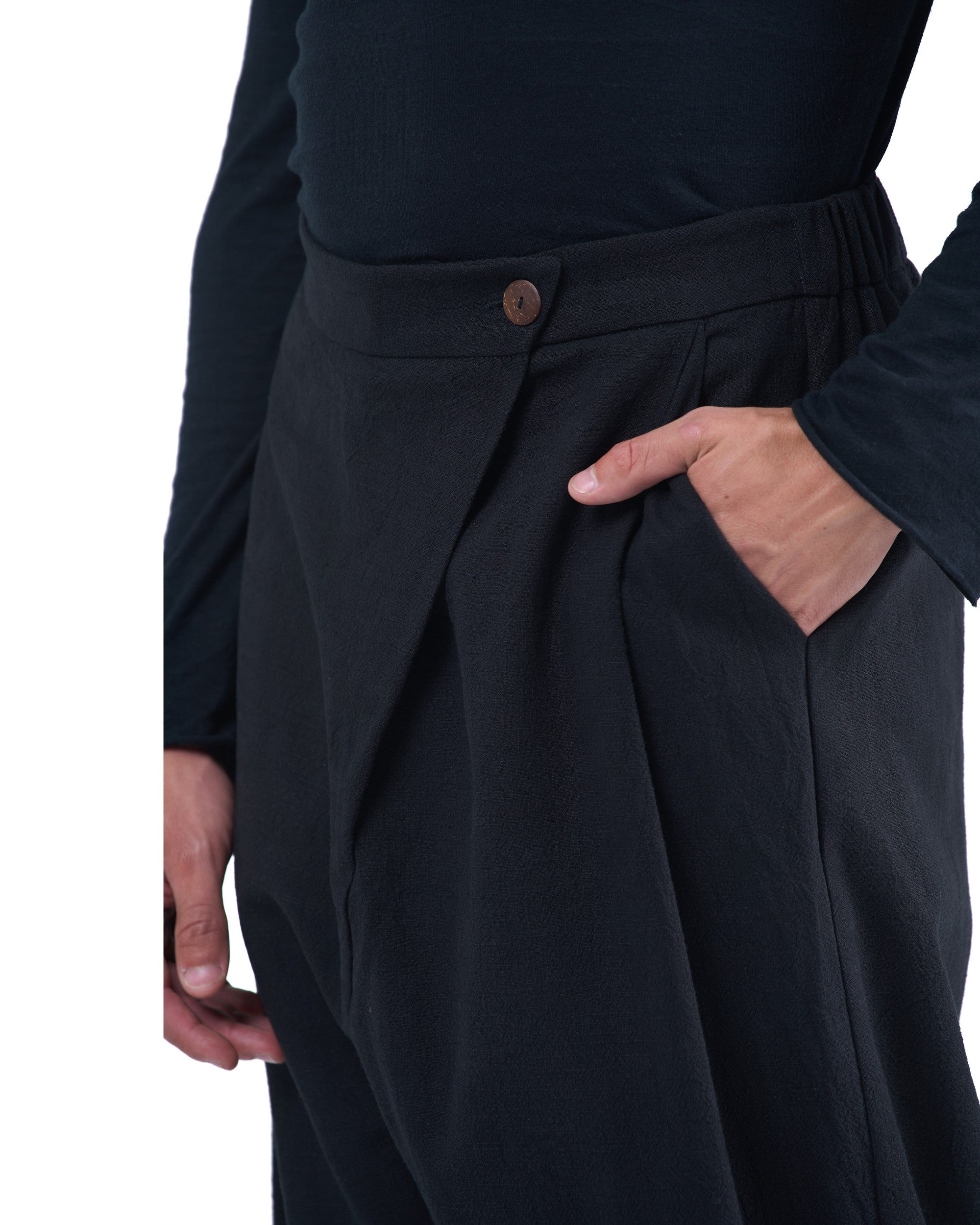 Black asymmetric jogger pants with elastic cuffs and textured fabric by OVERZ