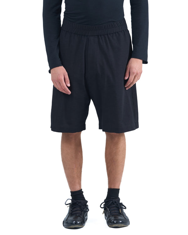 Black textured cotton shorts with leather side inserts and knee-length cut by OVERZ