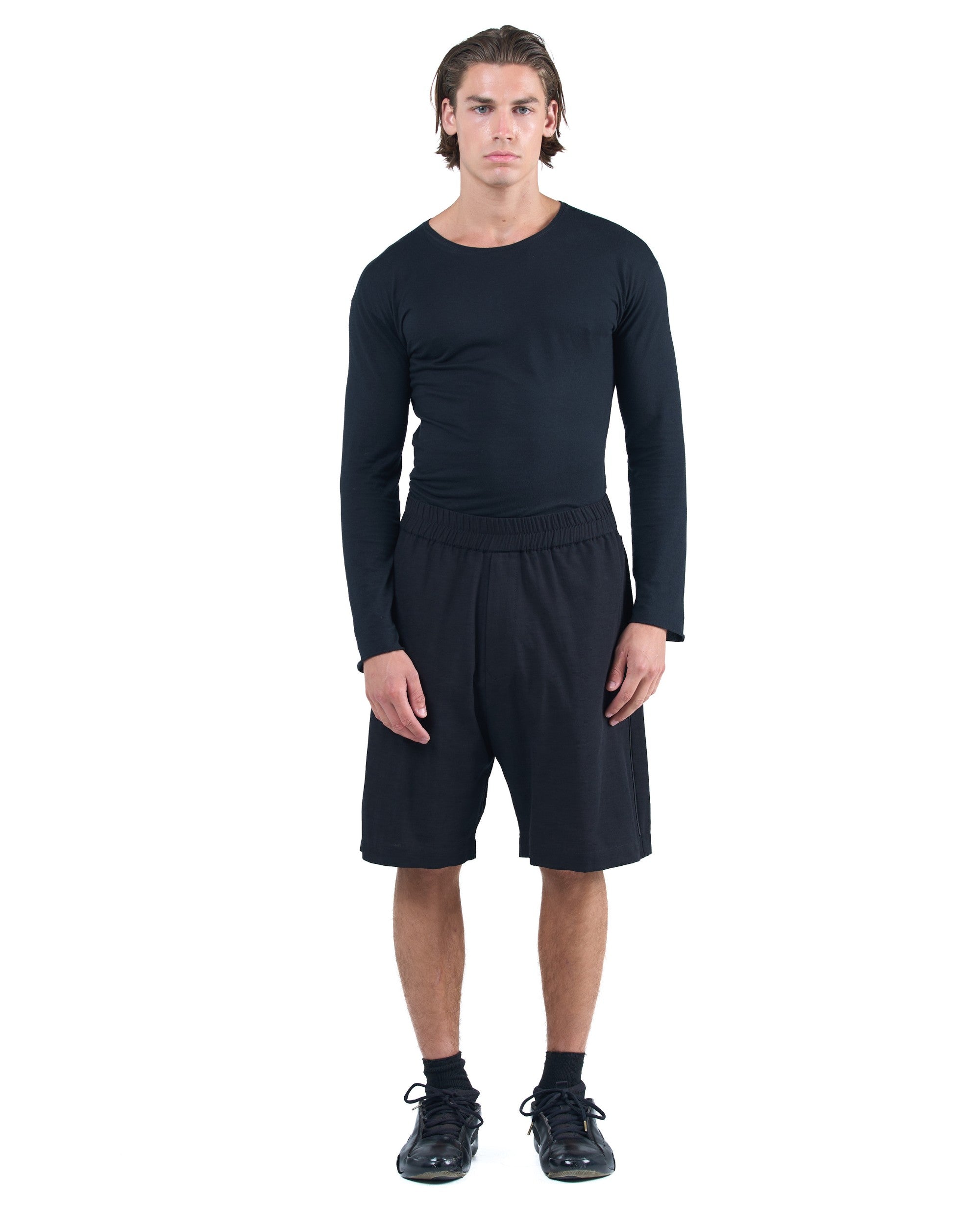 Black textured cotton shorts with leather side inserts and knee-length cut by OVERZ