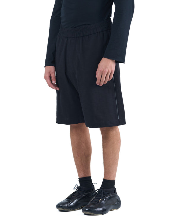 Black textured cotton shorts with leather side inserts and knee-length cut by OVERZ