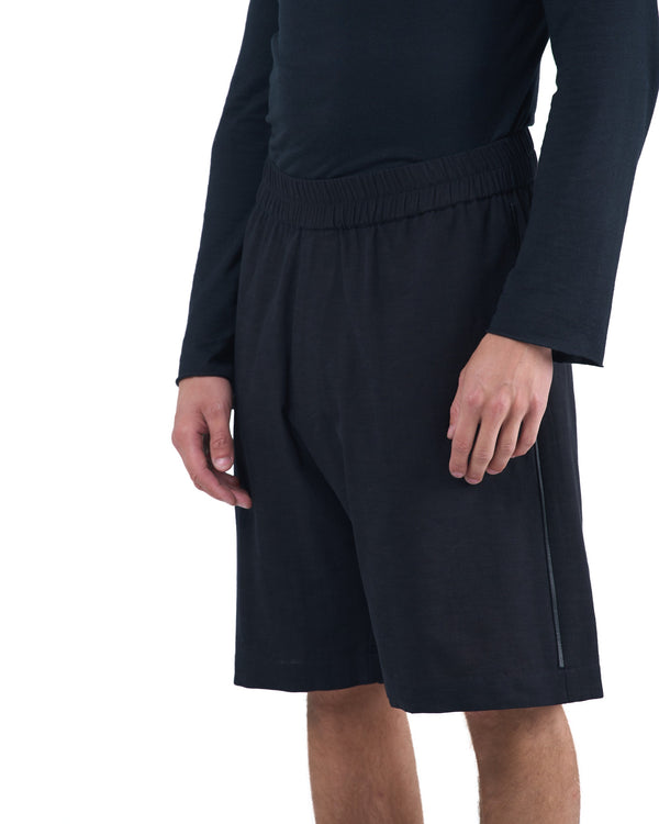 Black textured cotton shorts with leather side inserts and knee-length cut by OVERZ