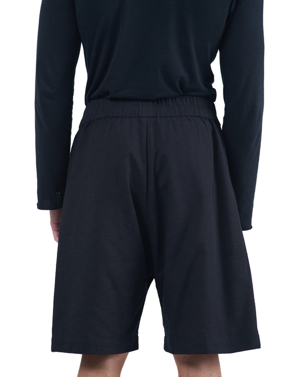 Black textured cotton shorts with leather side inserts and knee-length cut by OVERZ