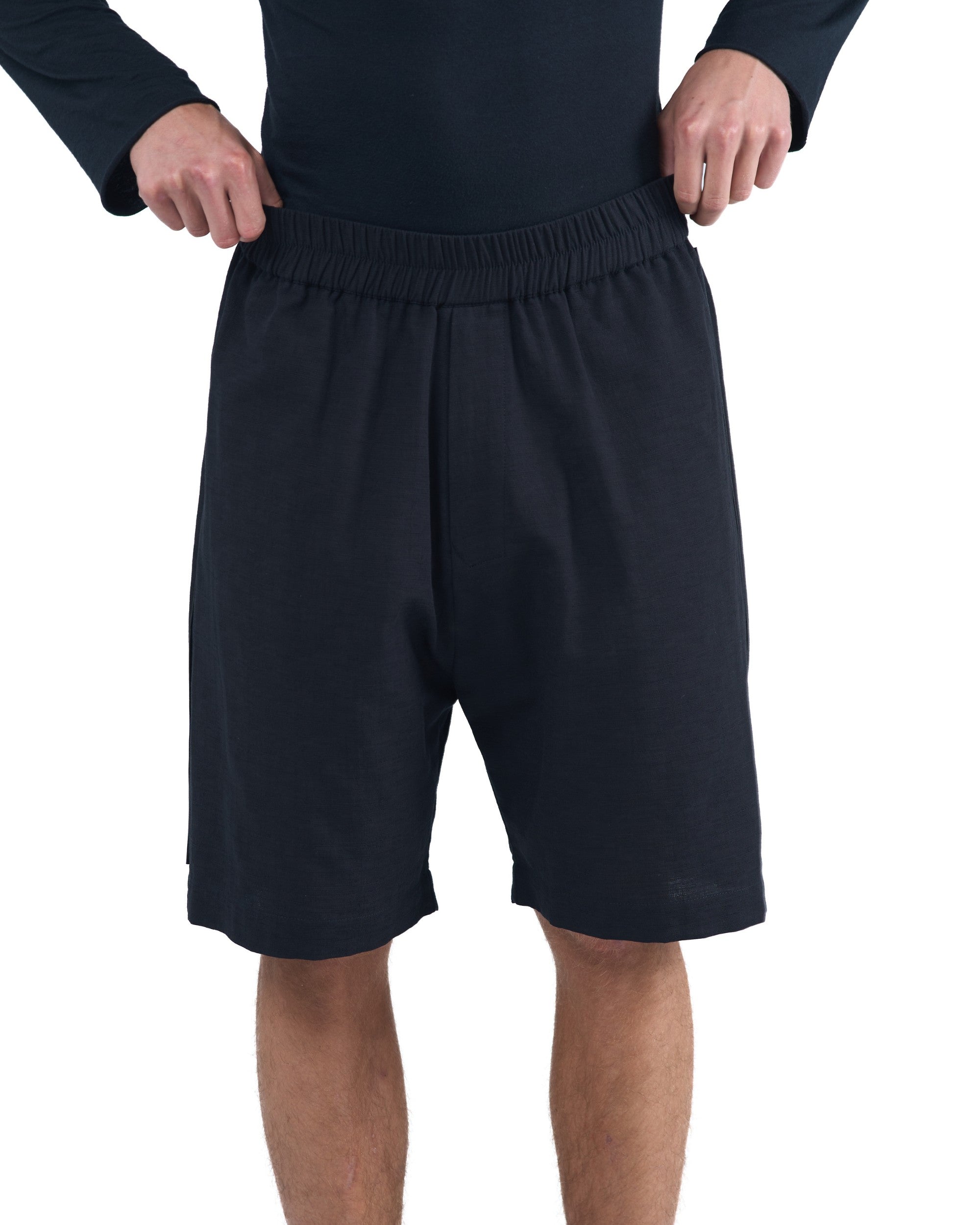 Black textured cotton shorts with leather side inserts and knee-length cut by OVERZ