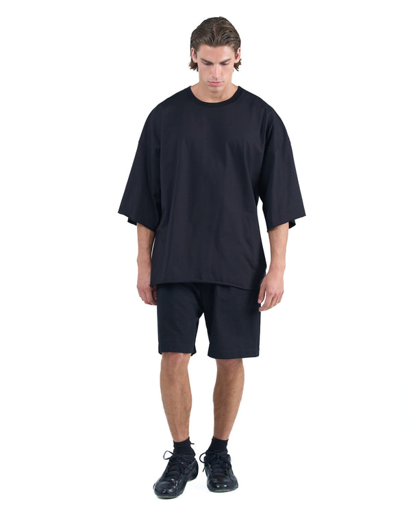 Black textured cotton shorts with leather side inserts and knee-length cut by OVERZ