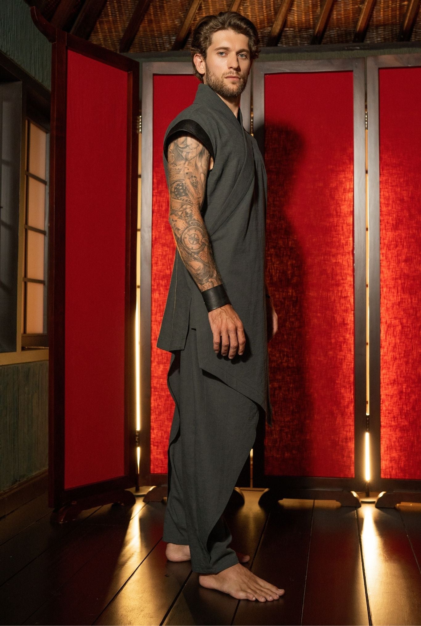 Designer black wrap top for men, close-up fabric texture and structure, OVERZ