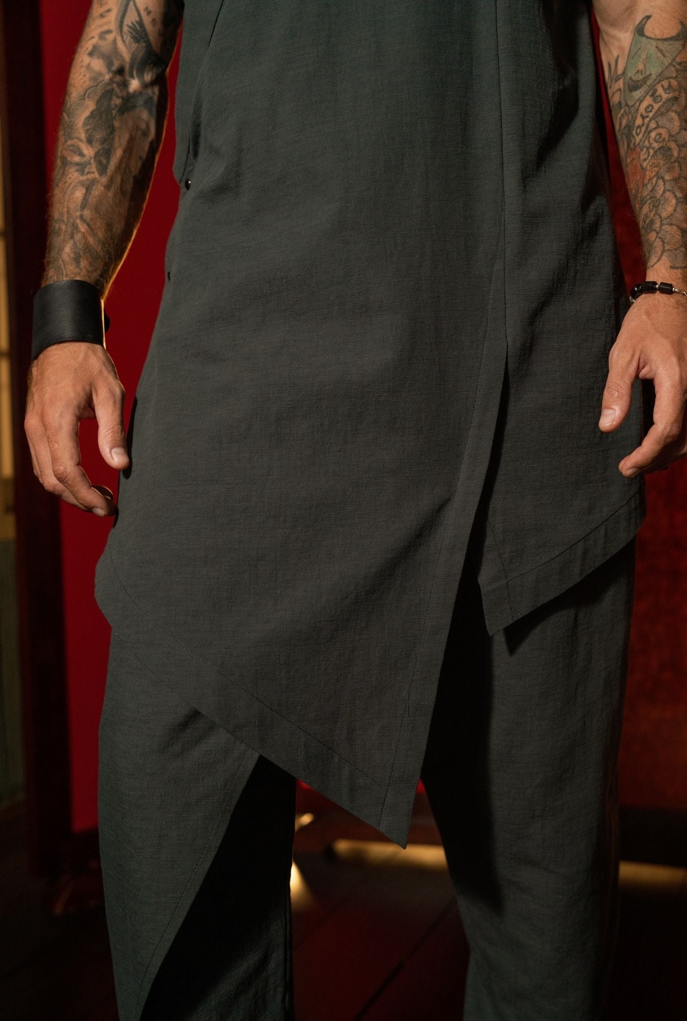 Asymmetric hem detail of black designer vest for men, conceptual tailoring OVERZ