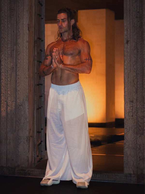 Black lightweight sheer pants with a loose fit and zippered pockets, made from airy translucent fabric — ideal for hot weather, layering, and bold, expressive styling.